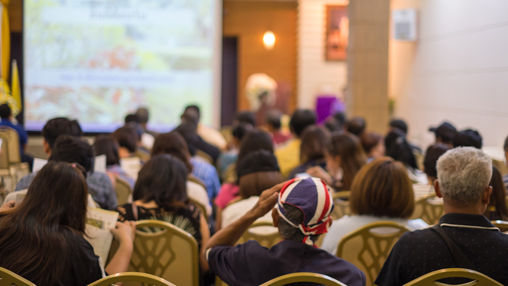 People sitting at a community meeting web One Westside Resident Meeting with USI One Westside
