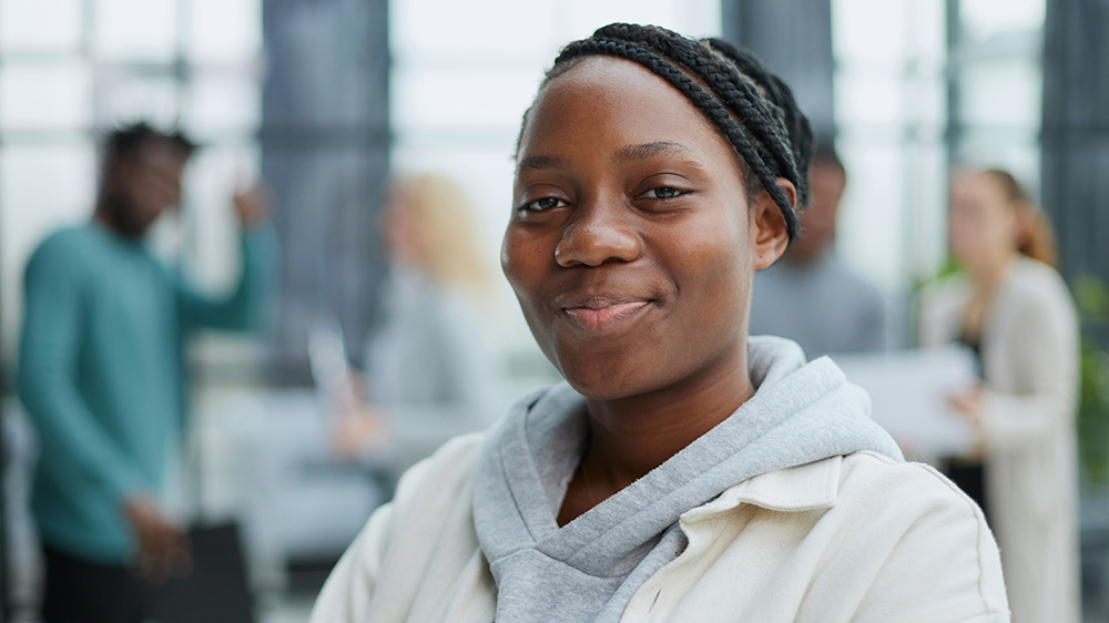 Happy young womand in work setting web Mobile American Job Center Outreach Event One Westside